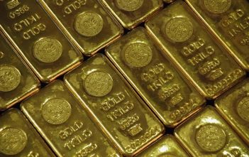 Gold Holds Near Record $3,500 Amid Trump–Fed Clash and Trade Tensions Gold bars representing record high prices amid economic tensions