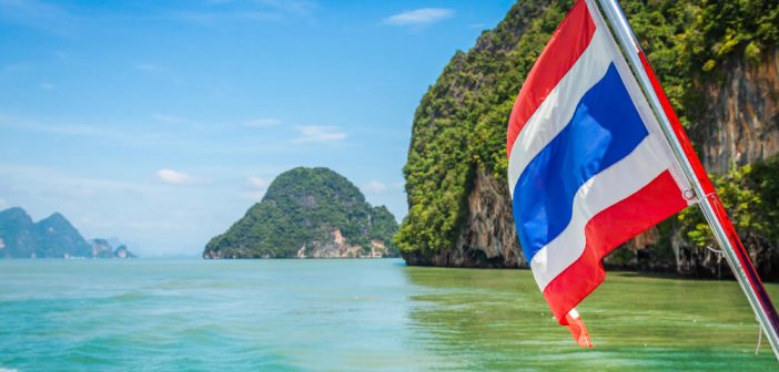 Tourist using crypto wallet in Thailand with temples in background