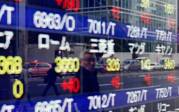Stock market graphs showing downward trends in Asian markets