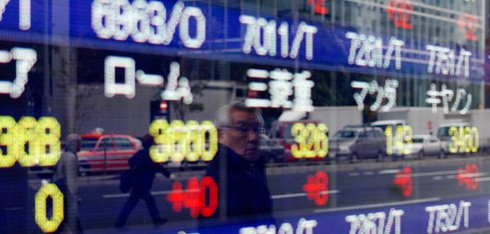Stock market graphs showing downward trends in Asian markets