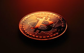 Bitcoin logo with upward chart and declining transaction icons