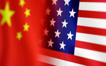 Flags of China and U.S. with chip and trade graphics