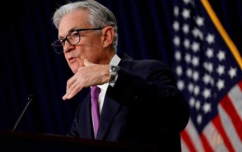 Federal Reserve building with economic indicators overlay