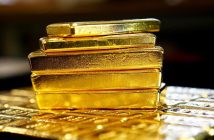 Gold bars with declining price chart reflecting market trends
