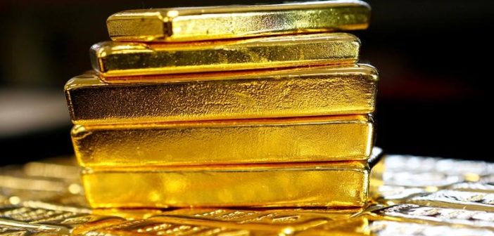 Gold bars with declining price chart reflecting market trends