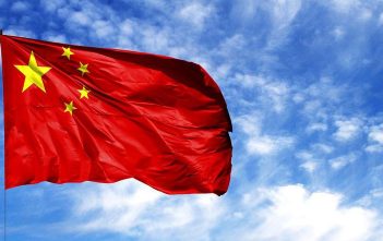 Chinese flag over Bitcoin and Ethereum symbols with warning icon