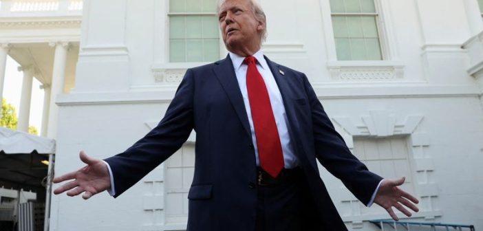 Donald Trump speaking with U.S. financial markets in the background
