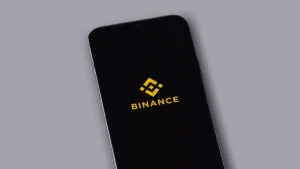 Binance warning sign with crossed-out robot icon and Alpha Points badge