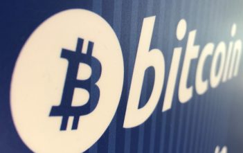 Bitcoin symbol with downward trend graph reflecting market decline