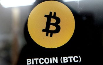Bitcoin symbol with downward arrow and Middle East map representing price drop amid conflict