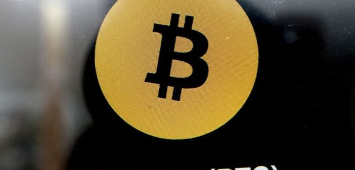 Bitcoin symbol with downward arrow and Middle East map representing price drop amid conflict