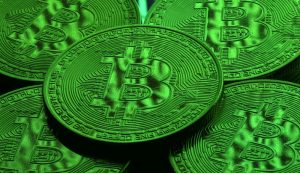 Bitcoin symbol with declining graph indicating price drop
