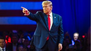 Donald Trump speaking on screen at Coinbase crypto event
