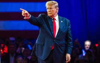 Donald Trump speaking on screen at Coinbase crypto event