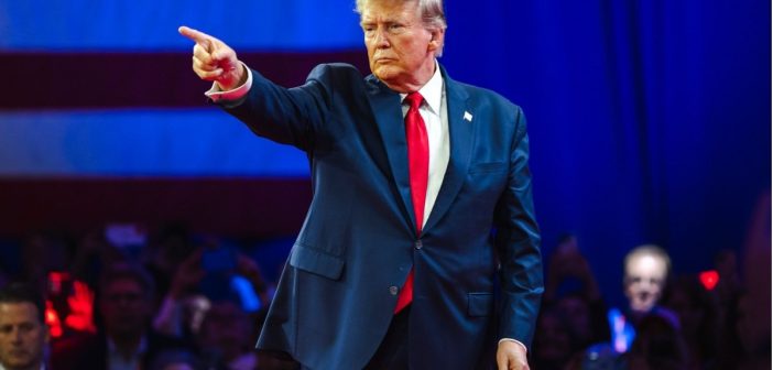Donald Trump speaking on screen at Coinbase crypto event