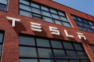 Conceptual illustration of a Tesla-branded drone flying over a cityscape
