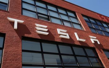 Conceptual illustration of a Tesla-branded drone flying over a cityscape