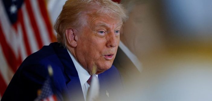 Donald Trump speaking with Iranian and Israeli flags in the background