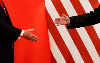 Flags of the United States and China with a handshake symbolizing the 2025 trade agreement