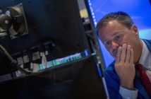 Stock market graph showing downward trend with Middle East map overlay