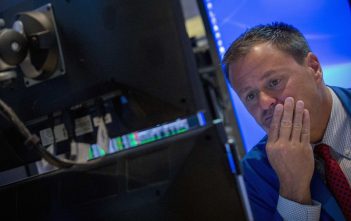 Stock market graph showing downward trend with Middle East map overlay
