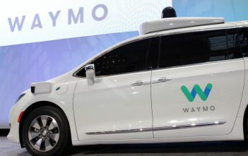 Damaged Waymo self-driving car on Los Angeles street during civil unrest